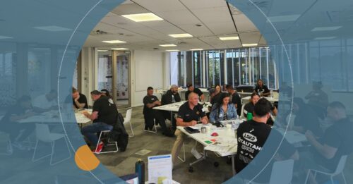 A group of participants engaged in a workshop at the Whakatupu Programme, collaborating and discussing in a bright, modern workspace.